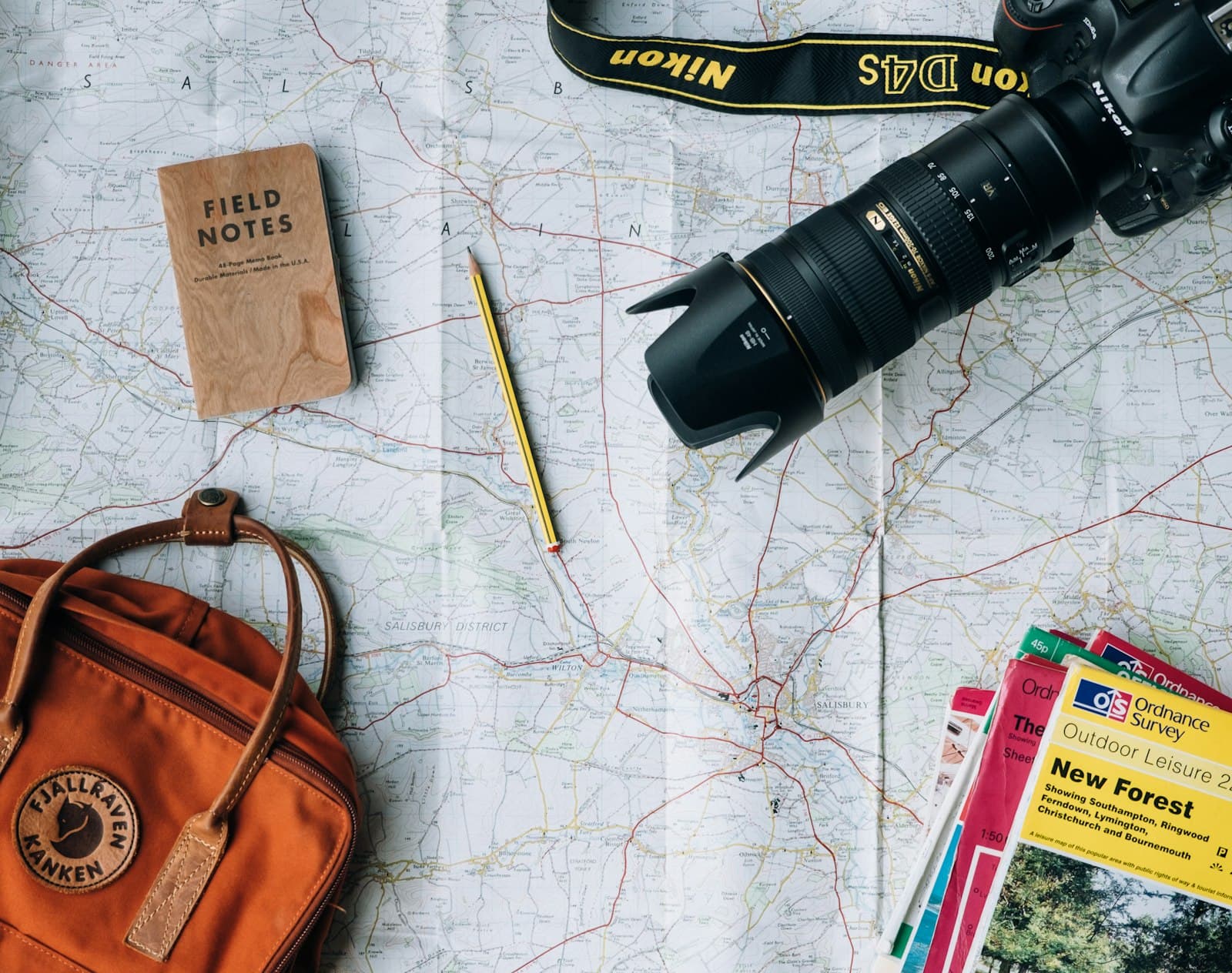 Travel documents, map and camera flat lay